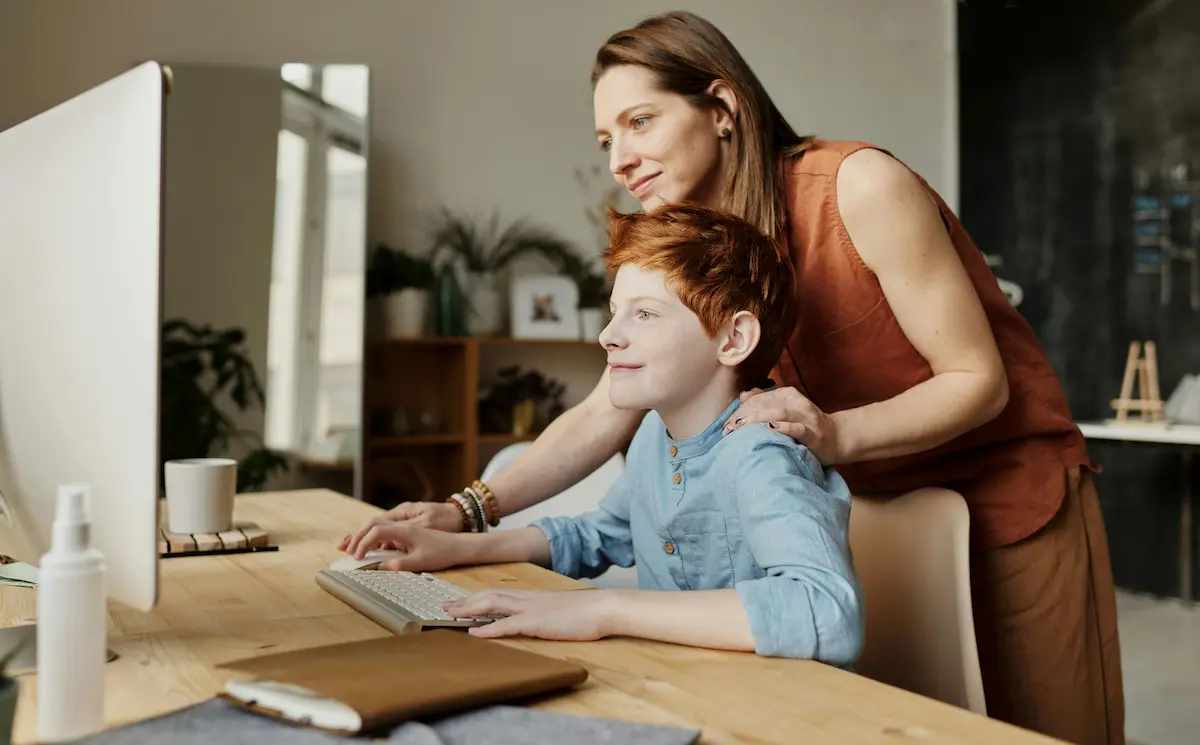 A young boy studying online in house